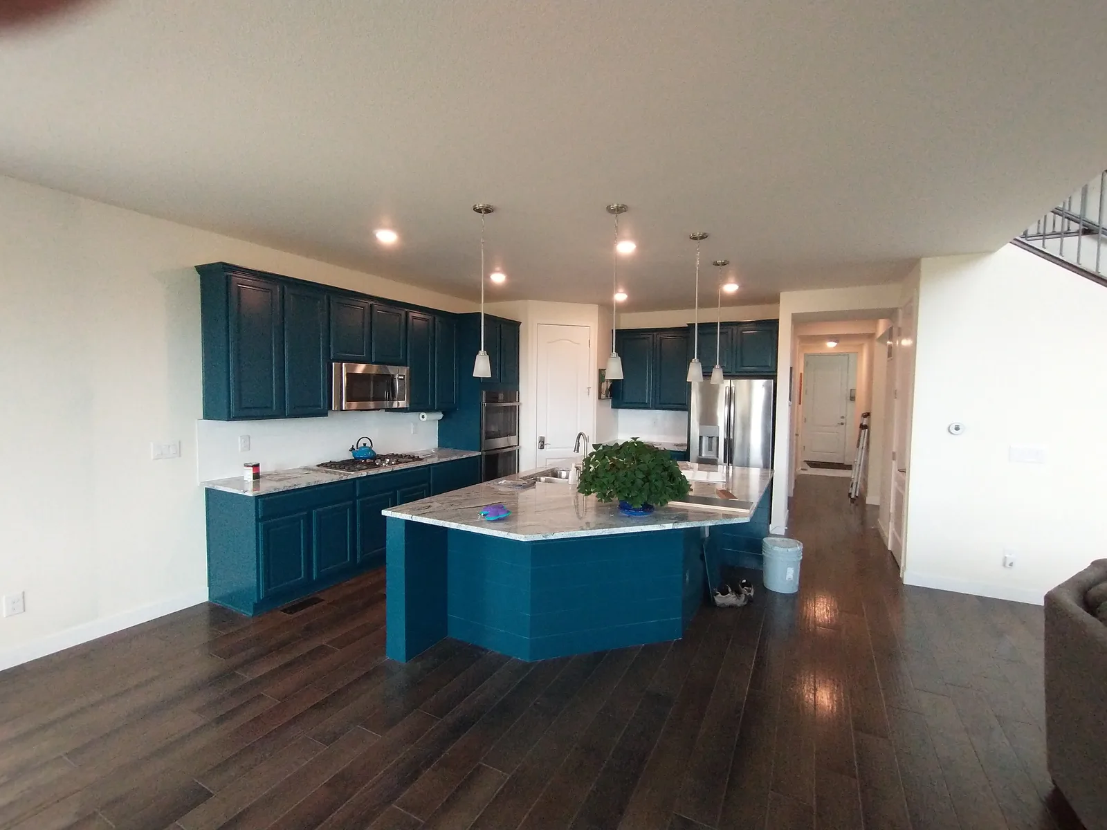 Mid-size kitchen with deep teal refinished cabinets and matching island