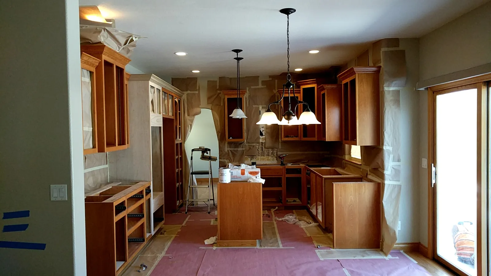 Before: the original golden oak kitchen, masked for finishing