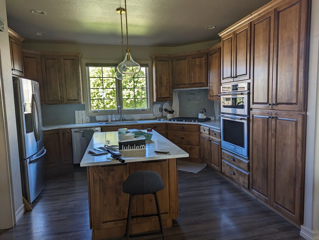Kitchen with dated oak cabinet doors before refacing