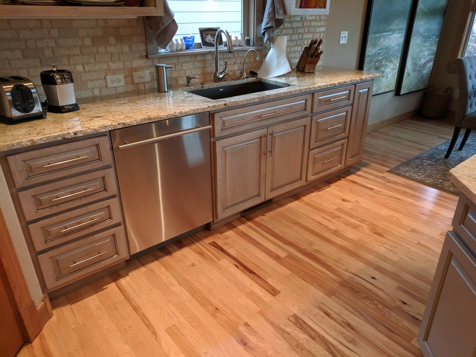 Warm, freshly finished kitchen with maple cabinets and hardwood floors in a Northern Colorado home